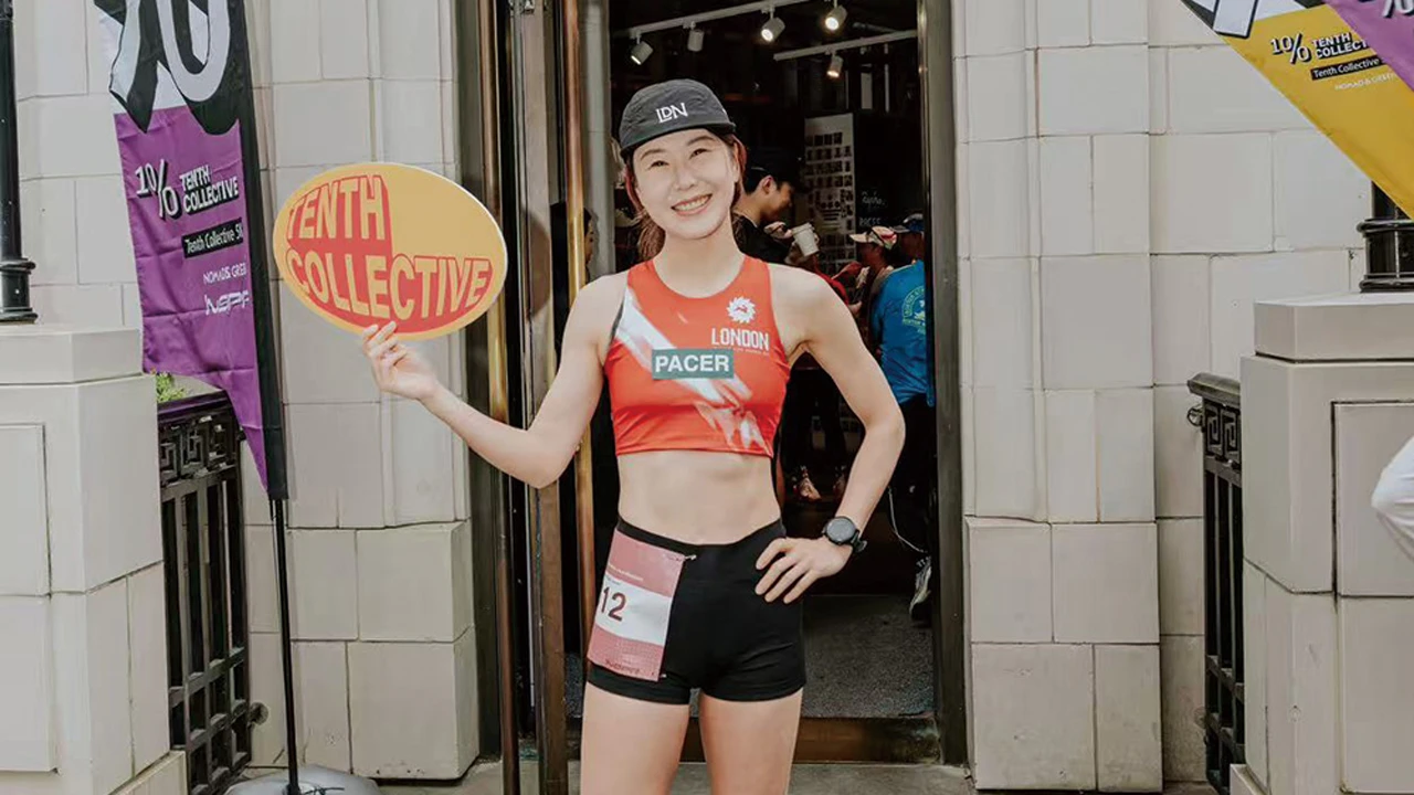 'London Pacer' athlete showcasing TENTH COLLECTIVE 10% Challenge signage at running event