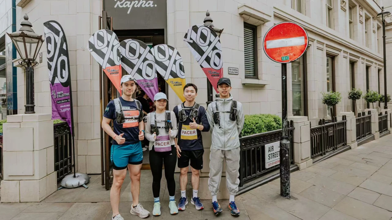 Certified pacers with race flags stationed outside Rapha cycling store pre-marathon