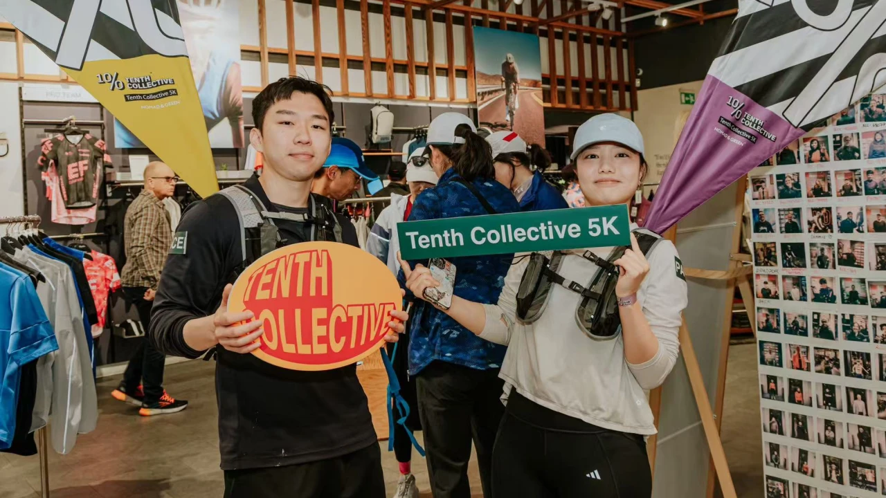 TENTH COLLECTIVE 5K indoor event: Pacers showcasing branded backpacks with race flags in sports retail environment