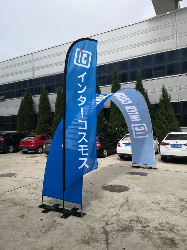 Blue custom printed arch banner stand with matching feather flag for outdoor promotional events