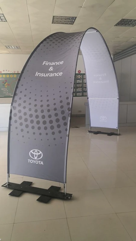 Gray Toyota finance and insurance arch banner stand with dot pattern design in indoor showroom