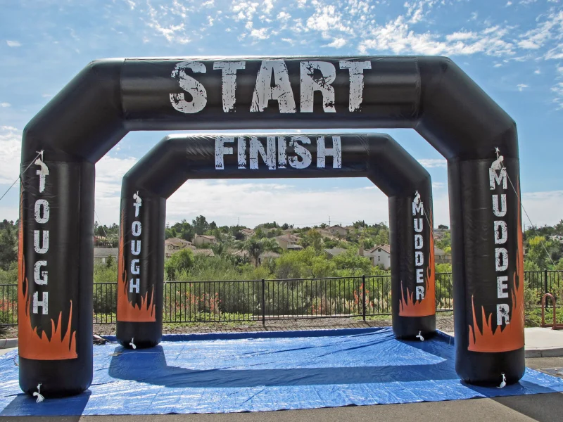 Black inflatable arch marked START and FINISH used for outdoor sports events.