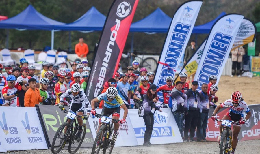 Feather flags at sports event with cyclists