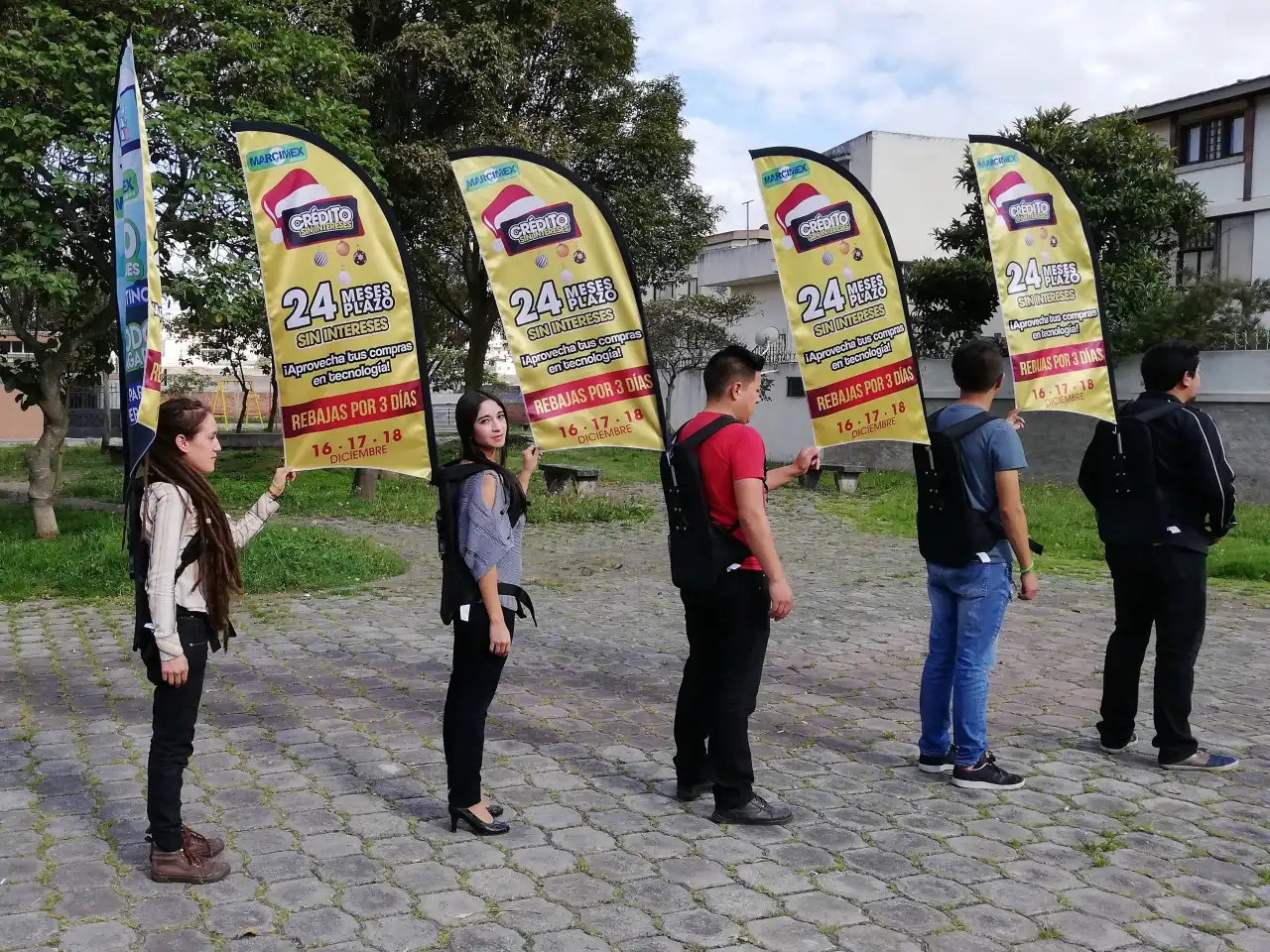 People wearing backpack flags for promotional event, showing 2025 mobile advertising trend and hybrid event flexibility
