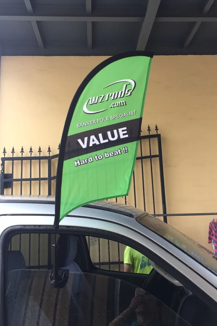 Green car window flag: 'BANNER POLE SPECIALIST' & 'VALUE' text.