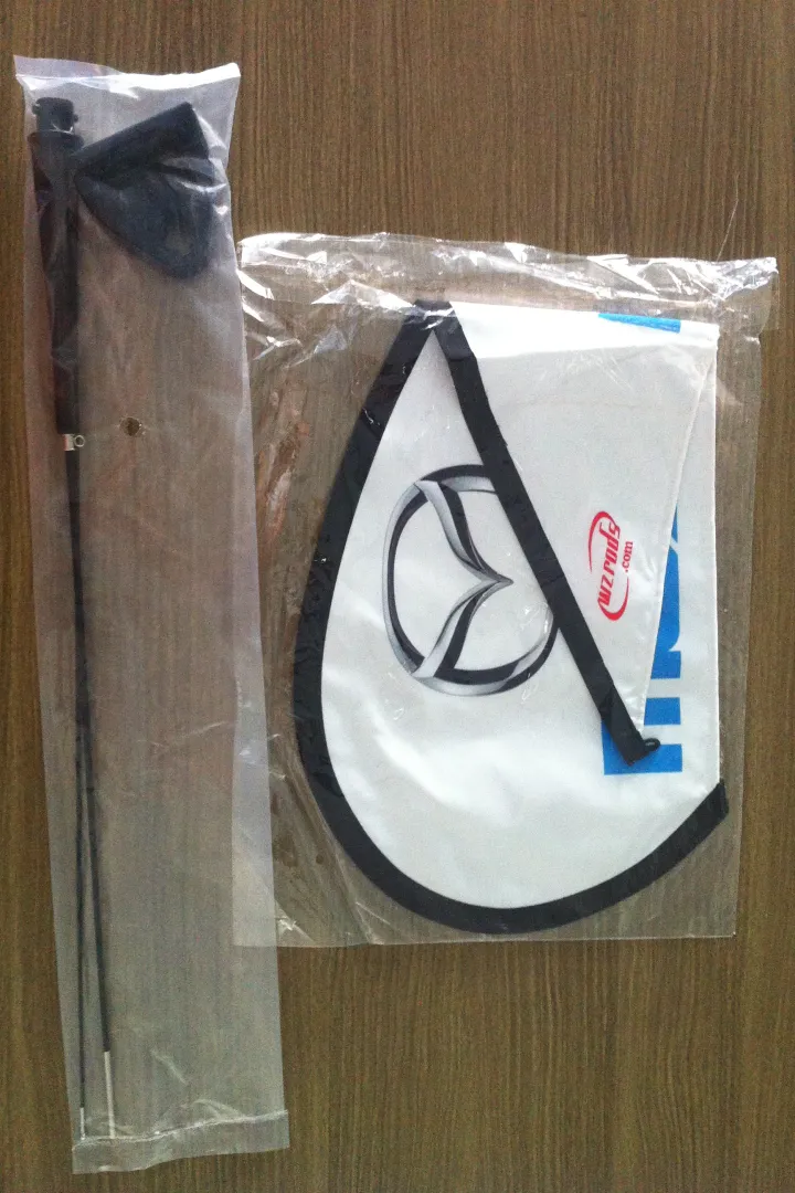 Car window flag kit: black carbon pole & white teardrop in packaging.