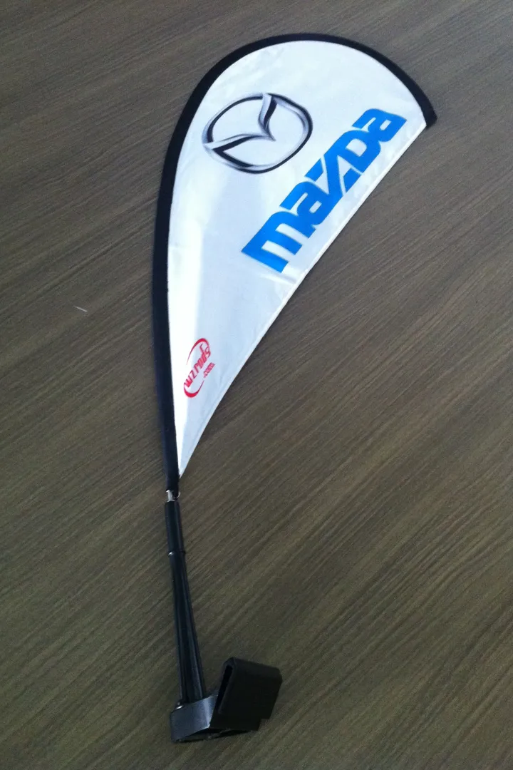 Mazda teardrop flag with logo, blue text on white and black base.