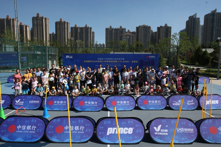 Indoor sports area with China Citic Bank sideline pop up banners and sports equipment, set for an event. 2019 China Tennis Junior