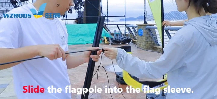 how to set up feather flags step3：slide the flagpole into the flag sleeve